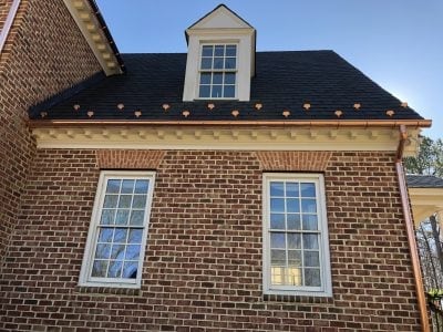 Brick colonial home with new copper gutters, dormer trim, and matching downspouts